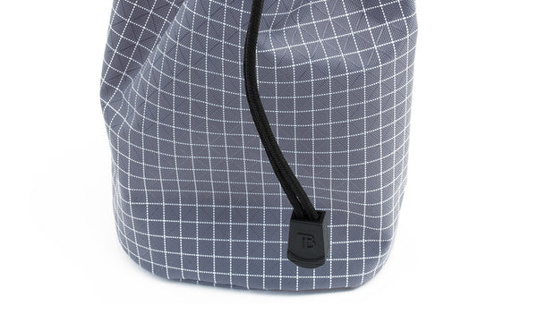 A close shot of the pull tab at the end of the drawstring on a Travel Stuff Sack.